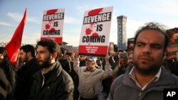 FILE - Iranian demonstrators hold anti-Saudi placards in a rally to protest the execution by Saudi Arabia last week of Sheikh Nimr al-Nimr, a prominent opposition Saudi Shiite cleric, in Tehran, Iran, Jan. 4, 2016. 