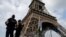 FILE - French police patrol near the Eiffel tower as part of security measures in Paris, France, July 13, 2017. 