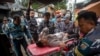 Rescue personnel transport a survivor from the site of a landslide triggered by heavy rains to a hospital in Mudal village, near Pekalongan city in Central Java, on Jan. 22, 2025.