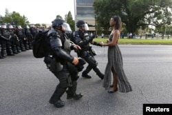 Protestor Ieshia Evans is detained by law enforcement near the headquarters of the Baton Rouge Police Department in Baton Rouge, Louisiana, July 9, 2016.
