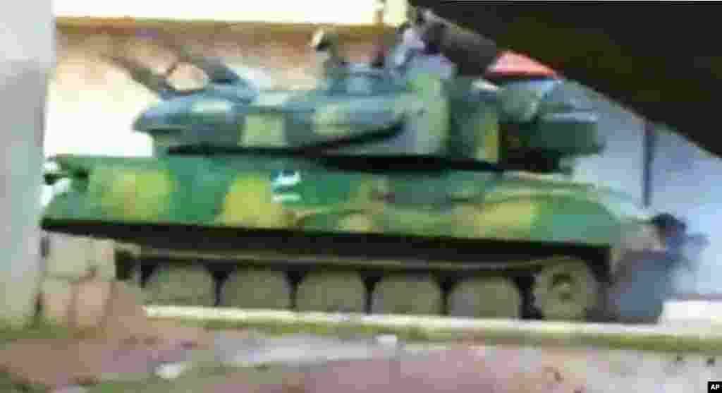 This image from amateur video purports to show a Syrian military tank in Daraa, February 16, 2012. (AP / Shaam)