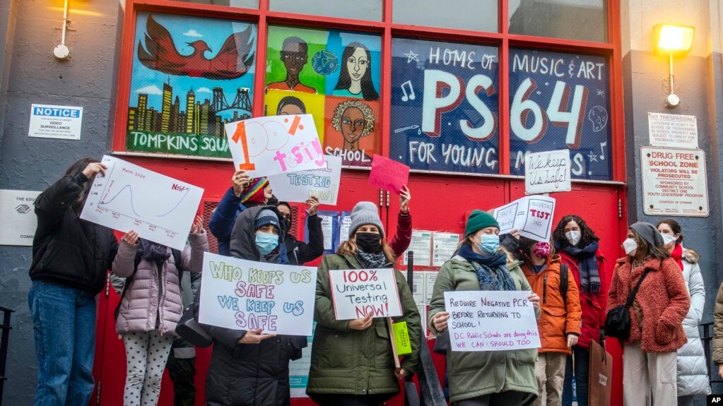 Teachers from the Earth School speak out on issues related to lack of coronavirus testing outside P.S. 64, Dec. 21, 2021, in New York. (AP Photo/Brittainy Newman, File)