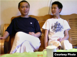 Chinese dissident Huang Qi is pictured with his son at their home in Chengdu, in southwest China's Sichaun province.