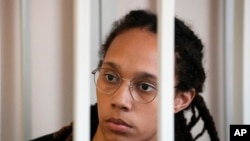FILE: WNBA star and two-time Olympic gold medalist Brittney Griner sits in a cage at a court room prior to a hearing, in Khimki just outside Moscow. Taken 7.27.2022