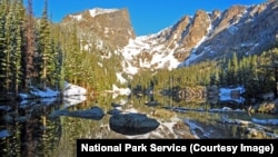 Dream Lake reflects the surrounding Rocky Mountains