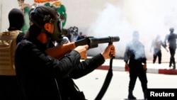 Police fire tear gas to break up a demonstration by the hardline Islamist group, Ansar al-Sharia May 19, in Kairouan, Tunisia.