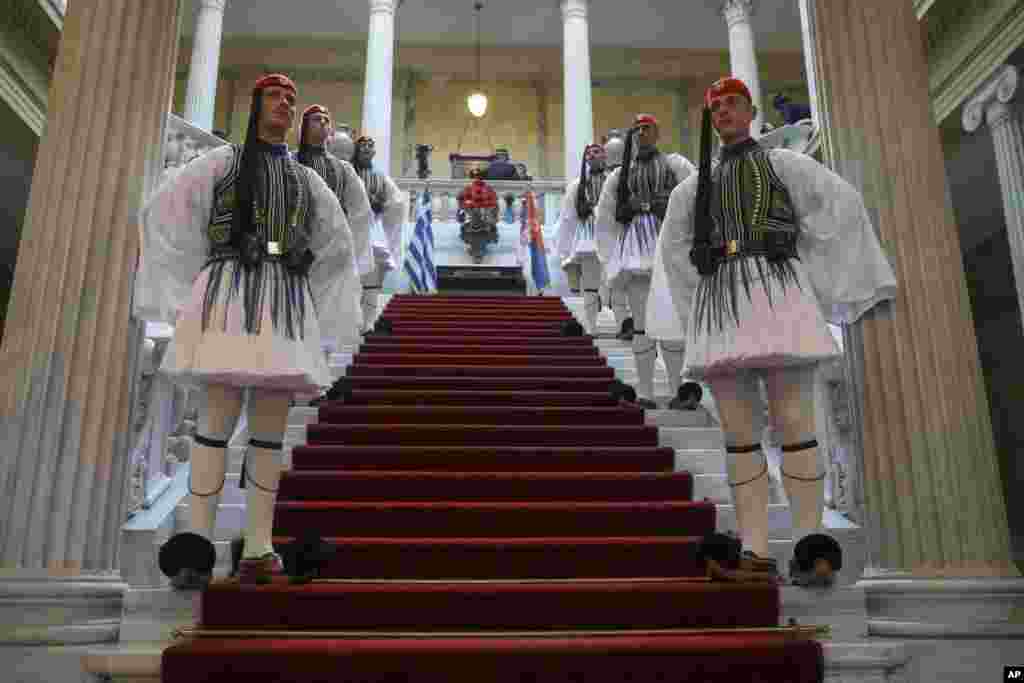 Greek Presidential guards stand inside the presidential palace during a welcome ceremony for the arrival of Serbian President Aleksandar Vucic, in Athens.
