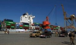 FILE - A loaded Chinese ship is readied for departure during a ceremony at Gwadar port, about 700 km west of Karachi, Pakistan, Nov. 13, 2016.