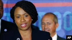Ayanna Pressley, who won the 7th Congressional District Democratic primary Tuesday, speaks at a Massachusetts Democratic Party unity event, Sept. 5, 2018, in Boston. At right is Jay Gonzalez, winner of the Massachusetts Democratic gubernatorial primary.