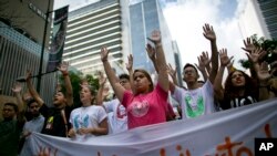 FILE - Students hold an anti-government protest to mark the third anniversary since the killing of student protester Bassil da Costa by security forces during weeks of unrest in Caracas, Venezuela, Feb. 12, 2017.