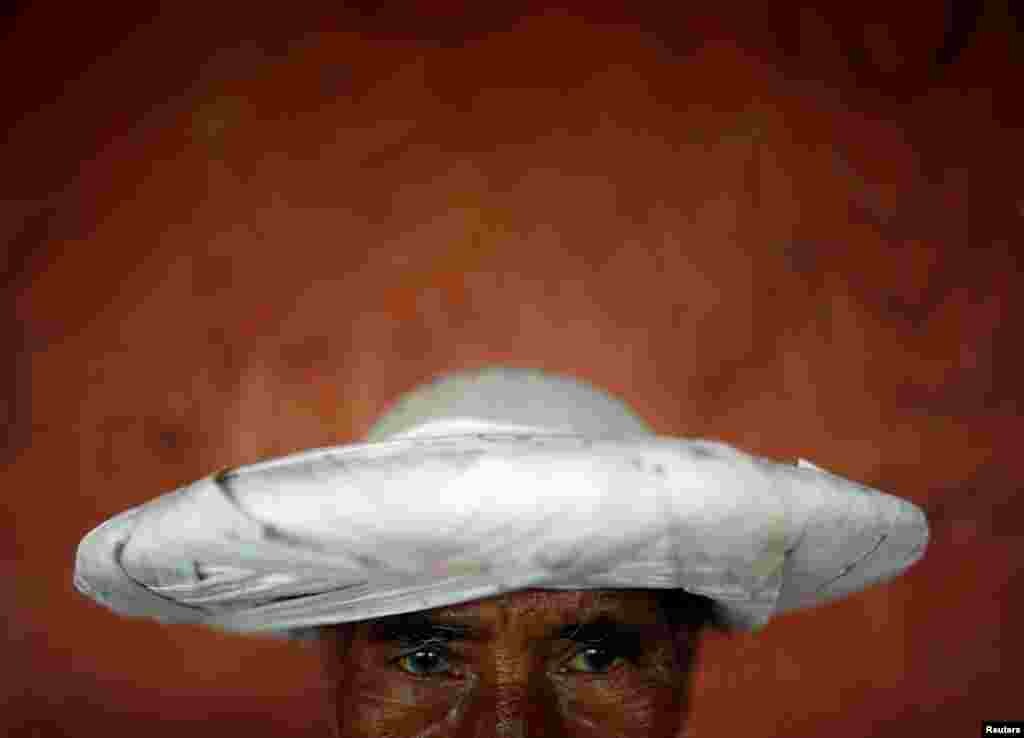 A priest in traditional attire takes part in the Shikali festival at Khokana village in Lalitpur, Nepal.