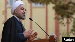 In this photo released by the official website of the office of the Iranian Presidency, Iran's President Hassan Rouhani speaks during a news briefing at the Presidency compound in Tehran, Nov. 24, 2013. 