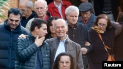 FILE - Convicted former Nazi SS officer Erich Priebke (C) and his lawyer, Paolo Giachini (L), are seen exiting a church after a mass in northern Rome October 17, 2010.
