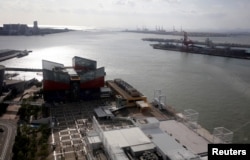 FILE - Factories line the port of Osaka, Japan, Oct. 23, 2017. Open shipping lanes ae seen as key for Japan to expand its economic influence in Asia.