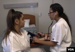 Students in the CNA class practice nursing skills on each other before working with patients.