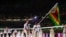 Tokyo 2020 Olympics - The Tokyo 2020 Olympics Opening Ceremony - Olympic Stadium, Tokyo, Japan - July 23, 2021. Flag bearers Peter Purcell-Gilpin of Zimbabwe and Donata Katai of Zimbabwe lead their contingent during the athletes' parade at the opening cer
