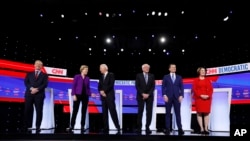 FILE - Democratic presidential candidates on debate stage in Demoines, Iowa, Jan. 14, 2020. 