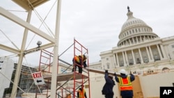 Construction continues on the Inaugural platform in preparation for the Inauguration and swearing-in ceremonies for President-elect Donald Trump on the Capitol steps in Washington. Trump will be sworn in a president on Jan. 20, 2017. (AP Photo/Pablo Martinez Monsivais)