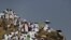 Muslim pilgrims visit Mount Mercy on the plains of Arafat during the annual haj pilgrimage, outside the holy city of Mecca, Sept. 23, 2015. 