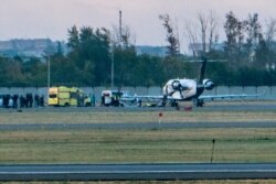 Russian opposition leader Alexei Navalny, center on stretcher, is transported to a German special medical plane at an airport in Omsk, Russia, Aug. 22, 2020.