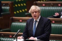 FILE - A handout photograph released by the U.K. Parliament shows Britain's Prime Minister Boris Johnson speaking about the COVID-19 pandemic at the House of Commons, in central London, May 12, 2021.