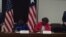 US Assistant Secretary for African Affairs Linda Thomas Greenfield and Liberian Foreign Minister Marjon Kamara sign a statement on US-Liberia cooperation.
