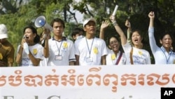 Social activists carry an anti-corruption banner during a rally in Phnom Penh.