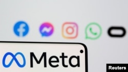 FILE Facebook's rebrand logo Meta is seen on smartphone in front of displayed logo of Facebook, Messenger, Instagram, WhatsApp and Oculus in this illustration picture taken October 28, 2021