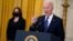 FILE - President Joe Biden speaks in the East Room of the White House as Vice President Kamala Harris listens, in Washington, May 10, 2021.
