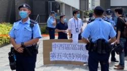 大批警員8月7日在中山紀念公園體育館外，截查到場抗議當地改建臨時火眼實驗室的幾名民主派中西區區議員，指他們違反公眾地方超過2人聚集的防疫限聚令。(美國之音湯惠芸拍攝)