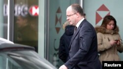Geneva's Attorney General Olivier Jornot leaves a HSBC Swiss branch of the bank in Geneva, Feb. 18, 2015.