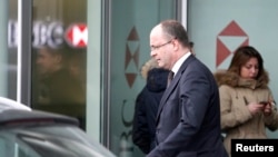 Geneva's Attorney General Olivier Jornot leaves a HSBC Swiss branch of the bank in Geneva, Feb. 18, 2015.