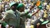 FILE: Zimbabwe's President Robert Mugabe and his wife Grace arrive to address the final rally of his ZANU-PF party in Harare, July 28, 2013. 