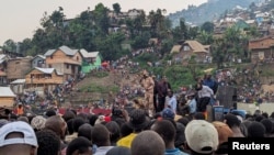 FILE - Congolese volunteers and former rebels gather in a rally to mobilize against the possible invasion by M23 rebels in Bukavu on Jan. 30, 2025