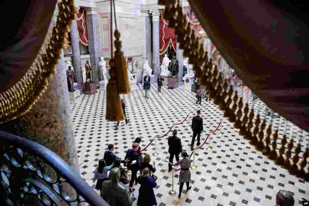 House Speaker Nancy Pelosi, bottom center, walks to the House Chamber as the House of Representatives takes up articles of impeachment against President Donald Trump, on Capitol Hill in Washington.