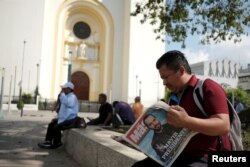 A man reads a newspaper with the picture of presidential candidate Nayib Bukele, who proclaimed himself the winner of the presidential election, in San Salvador, El Salvador, Feb. 4, 2019.