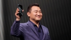 TM Roh, President and Head of Mobile Communications Business, holds a Samsung Galaxy S20 Ultra 5G phone while speaking at the Unpacked 2020 event in San Francisco, Tuesday, Feb. 11, 2020. (AP Photo/Jeff Chiu)