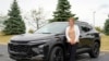 Michelle Chumley poses for a portrait beside her new Chevrolet Trax compact SUV, Sept. 26, 2024, in West Chester, Ohio.