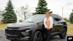 Michelle Chumley poses for a portrait beside her new Chevrolet Trax compact SUV, Sept. 26, 2024, in West Chester, Ohio.