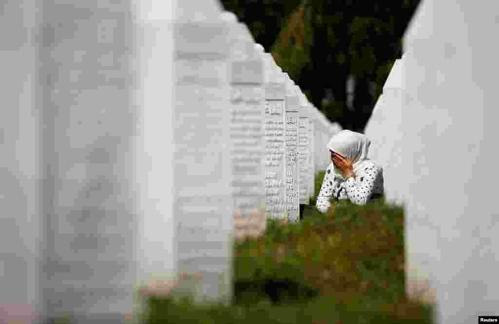 A woman cries at a graveyard, ahead of a mass funeral in Potocari near Srebrenica, Bosnia and Herzegovina, July 11, 2020.&nbsp;Bosnia marks the 25th anniversary of the massacre of more than 8,000 Bosnian Muslim men and boys, with many relatives unable to attend due to the COVID-19 outbreak.&nbsp;