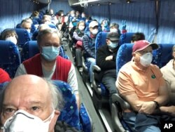 U.S. passengers on board the Diamond Princess cruise ship, who have chosen to leave, are transported by shuttle bus in Yokohama to Haneda airport to fly back to the United States via chartered evacuation aircraft, in Japan February 17, 2020.