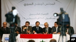Syrian opposition members (L to R) Ahmed Ramadan, Khaled Hassaleh, Hassan Hashmi, Lovay Safi, Abdul Basit Sida, Adip Shishakil and Hassan Shalabi attend a news conference after their meeting in Istanbul, August 23, 2011
