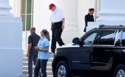 U.S. President Donald Trump, in golf attire, departs the White House for the drive to his Trump National Gold Club in Sterling, Virginia, in Washington, July 14, 2019.