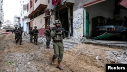 Israeli soldiers operate at the Shajaiya district of Gaza city amid the ongoing conflict between Israel and the Palestinian Islamist group Hamas, in the Gaza Strip