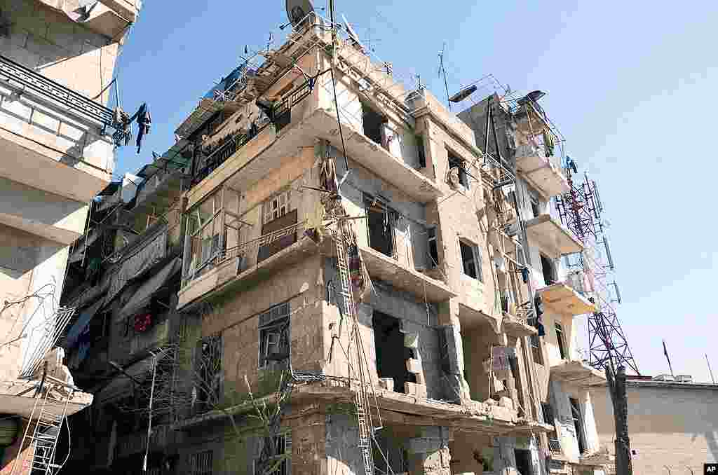 This photo released by the Syrian official news agency shows a building damaged in a blast in Aleppo, Syria, March 18, 2012. (AP/SANA)