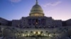 FILE - The sun rises behind the U.S. Capitol as a rehearsal begins on the West Front ahead of President-elect Donald Trump's upcoming inauguration in Washington, Jan. 12, 2025.