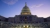 FILE - The sun rises behind the U.S. Capitol as a rehearsal begins on the West Front ahead of President-elect Donald Trump's upcoming inauguration in Washington, Jan. 12, 2025.