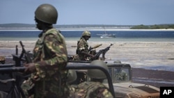 Kenyan army soldiers sit in their armored vehicles. The Kenyan military says it's getting ready to push forward with its offensive against the al-Shabab insurgents, December 14, 2011.