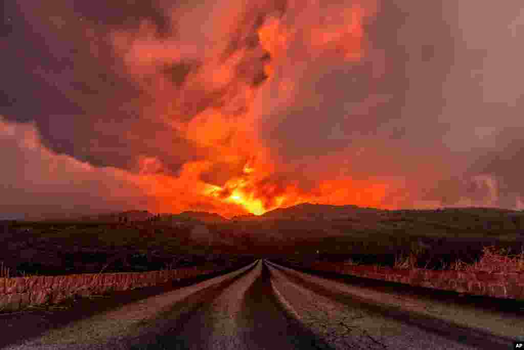 A glowing river of lava gushes from the slopes of Mt Etna, Europe&#39;s largest active volcano, near Zafferana Etnea, Sicily, Italy.