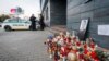 FILE - Police guard the entrance to the offices of news website Aktuality, the employer of murdered investigative journalist Jan Kuciak, in Bratislava, Slovakia, February 27, 2018. Peter Sabo, another Aktuality reporter, found a bullet in his mailbox.